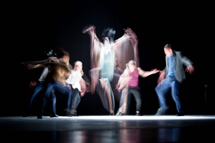 blurred image of people dancing on the stage 